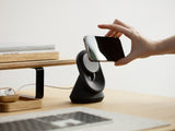 black magsafe iphone stand on a wooden desk | -