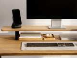 black magsafe iphone stand with iphone on a veneer desk shelf | black