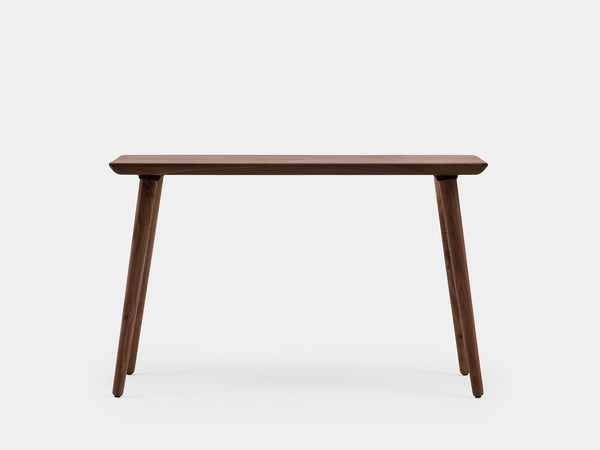 Black wood desk with black legs and slim rectangular top, studio shot.