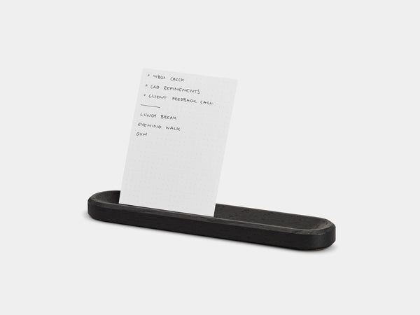 Black tray holding a to-do card on a white background | black