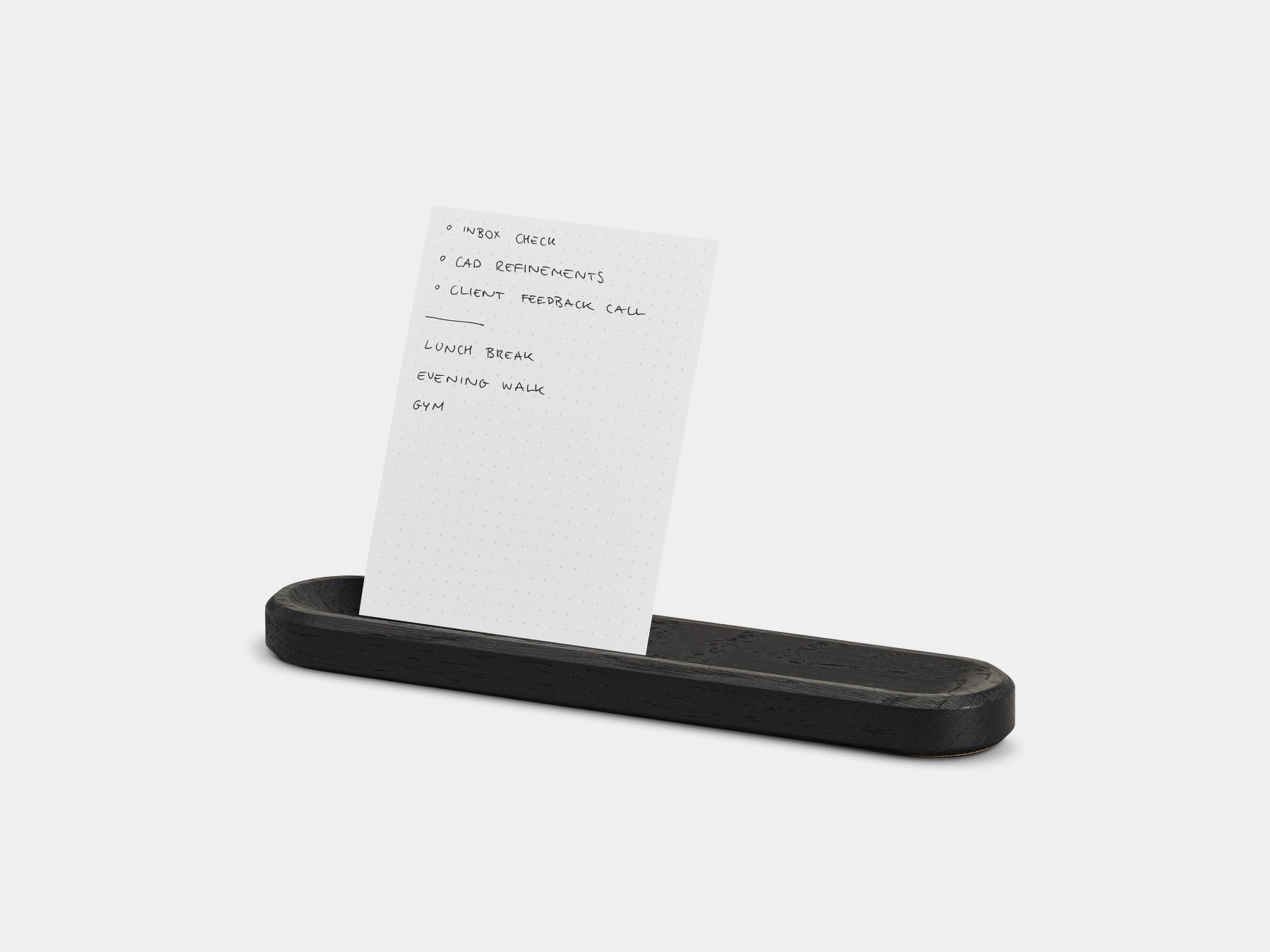 Black tray holding a to-do card on a white background | black