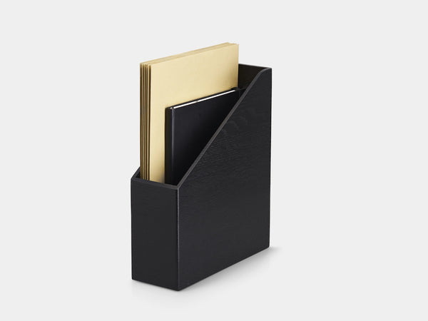 Black magazine holder with gold and black books on a white background| black