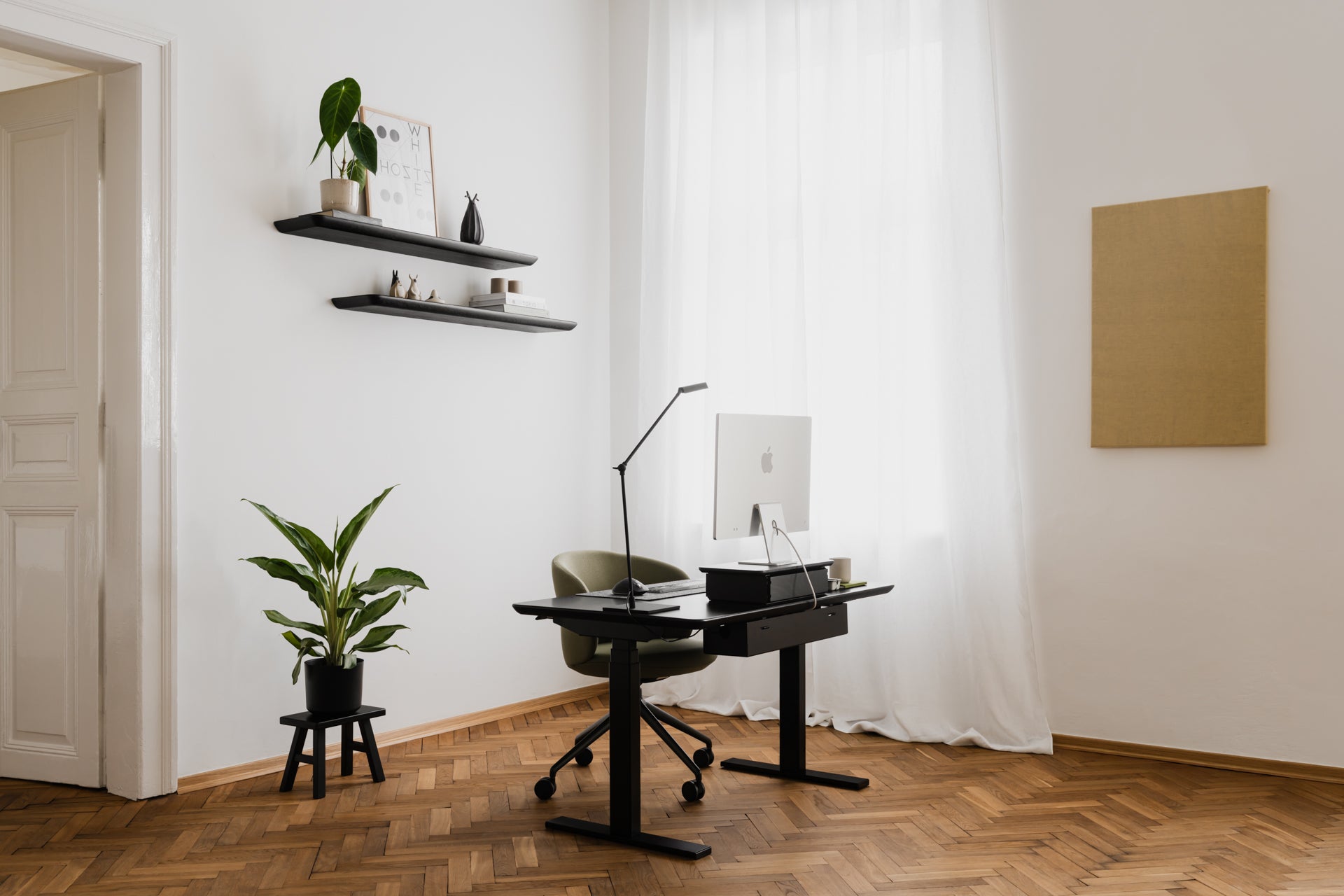 Modern home office with a desk, chair, and decor elements | black,