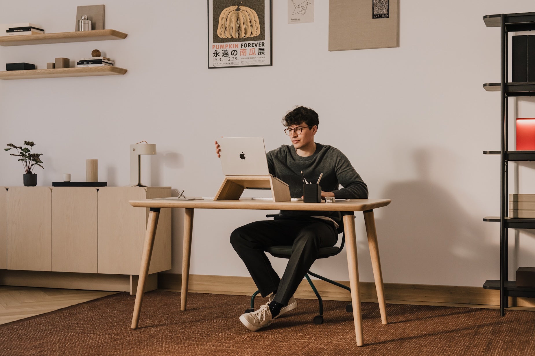 Person sitting at a desk with a laptop in a home office setting | light oak,