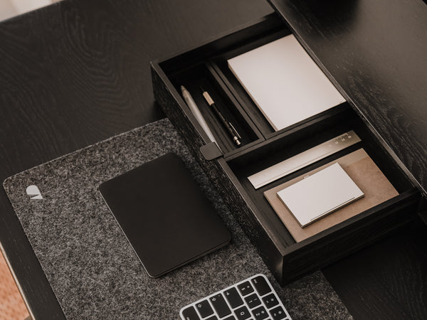 Desk setup with a black stationery set, mouse pad, and keyboard.  | black, 