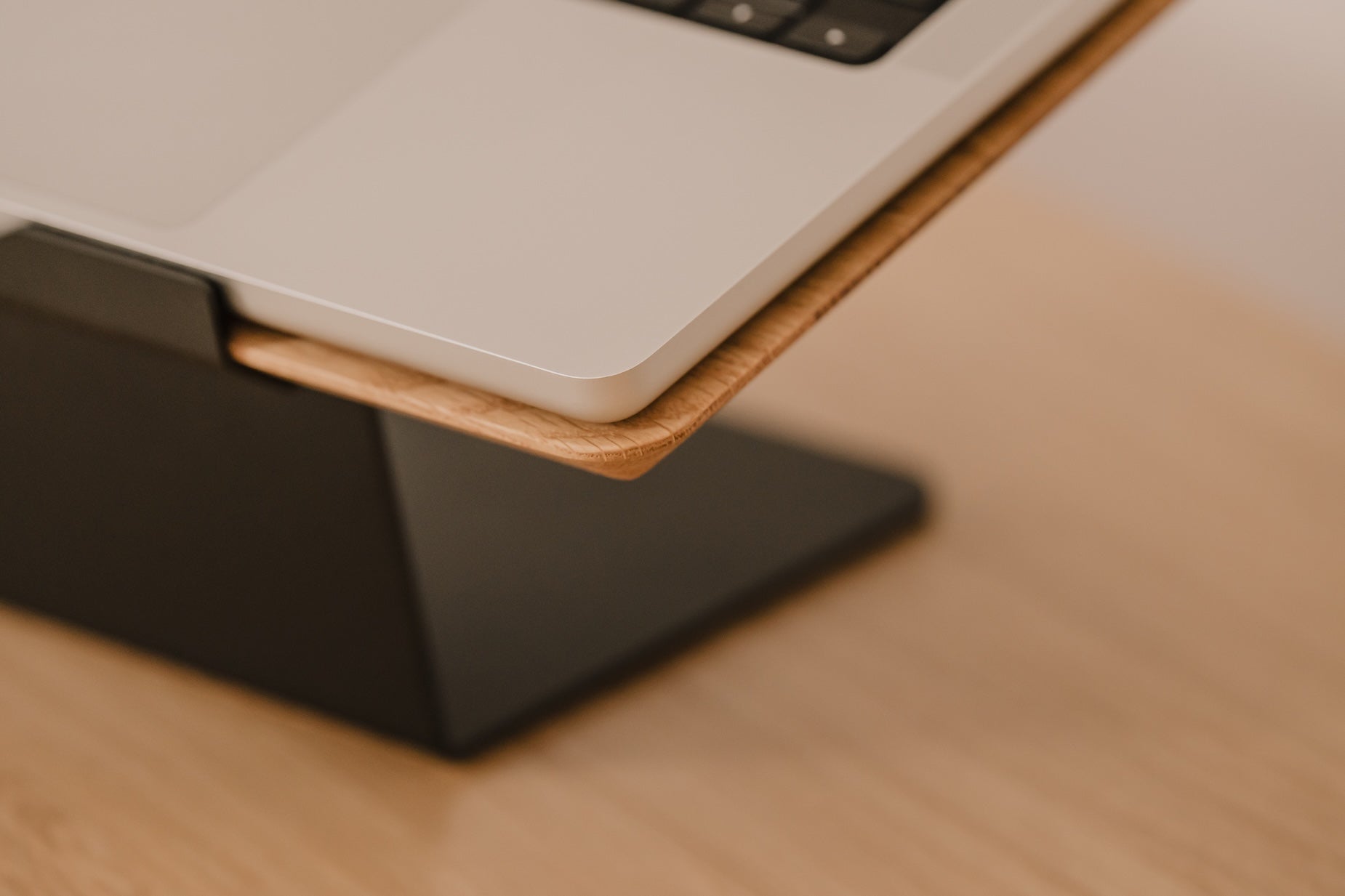 Laptop on a wooden stand with a blurred background | oak,