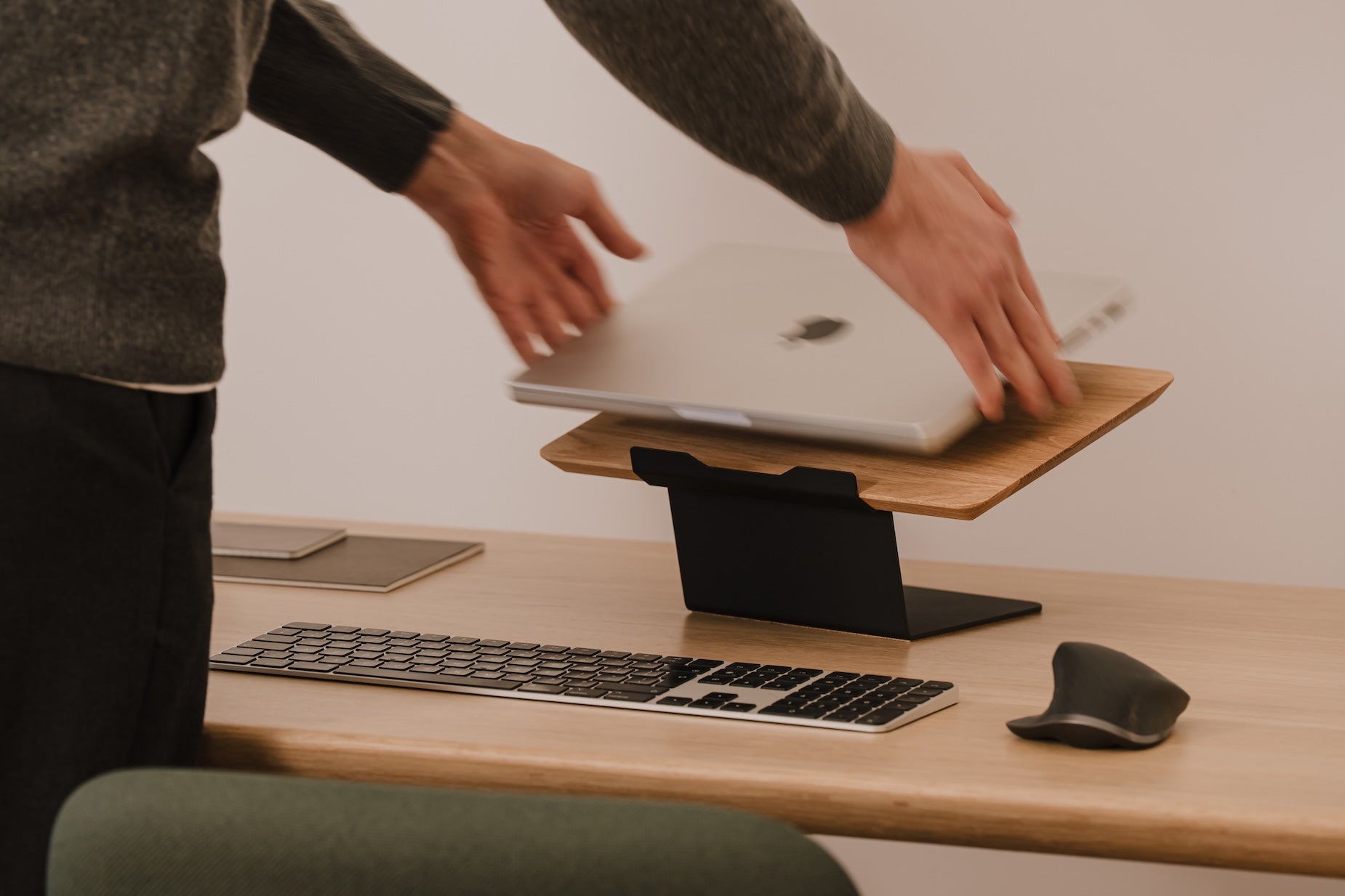 Person using a laptop on a wooden stand at a desk with a keyboard and mouse Oakywood Laptop Riser | oak,