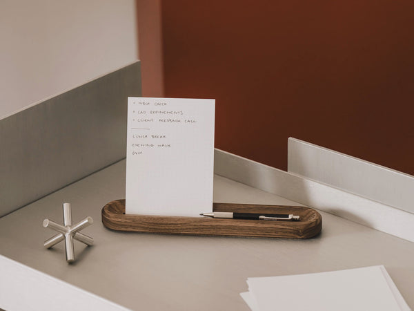 White card with text on a wooden tray on a desk | walnut