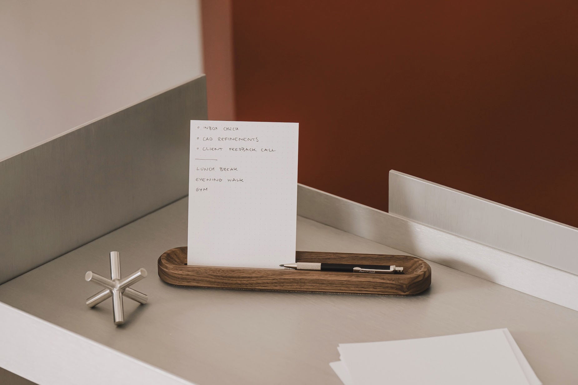 White card with text on a wooden tray on a desk | walnut