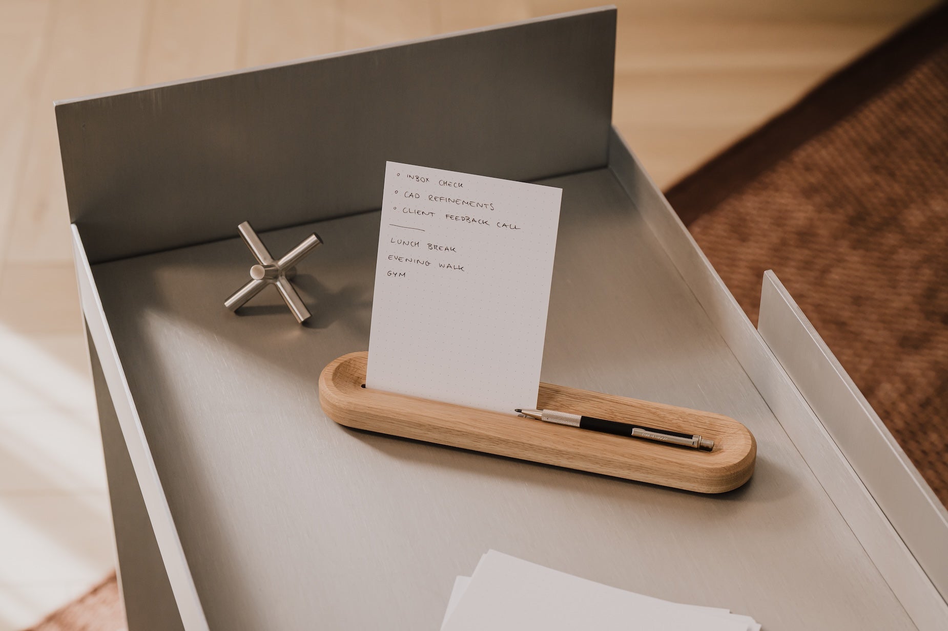 to-do list holder with a pen, small object, and paper on a wooden surface | oak