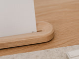 Wooden desk with a white dotted design oakywood to-do cards, placed against a light-colored wall |-