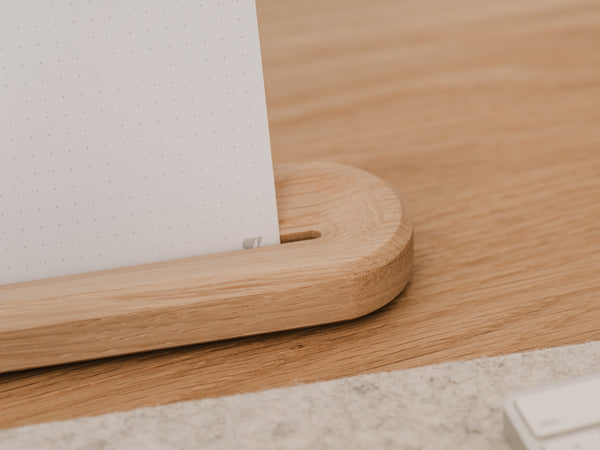 Wooden desk with a white dotted design oakywood to-do cards, placed against a light-colored wall |-