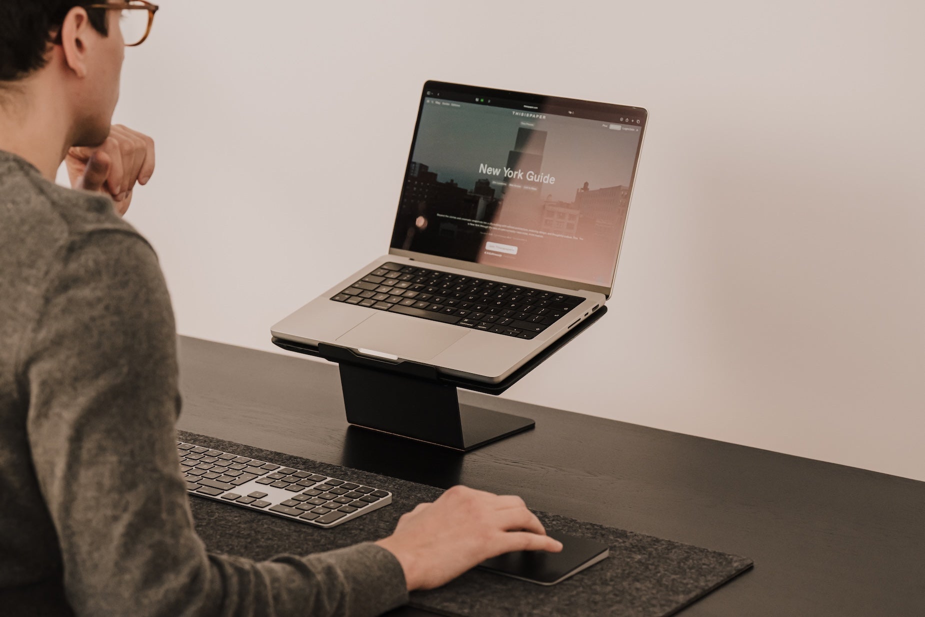 Person using a laptop on a stand at a desk with a minimal background Oakywood Laptop Riser | black,
