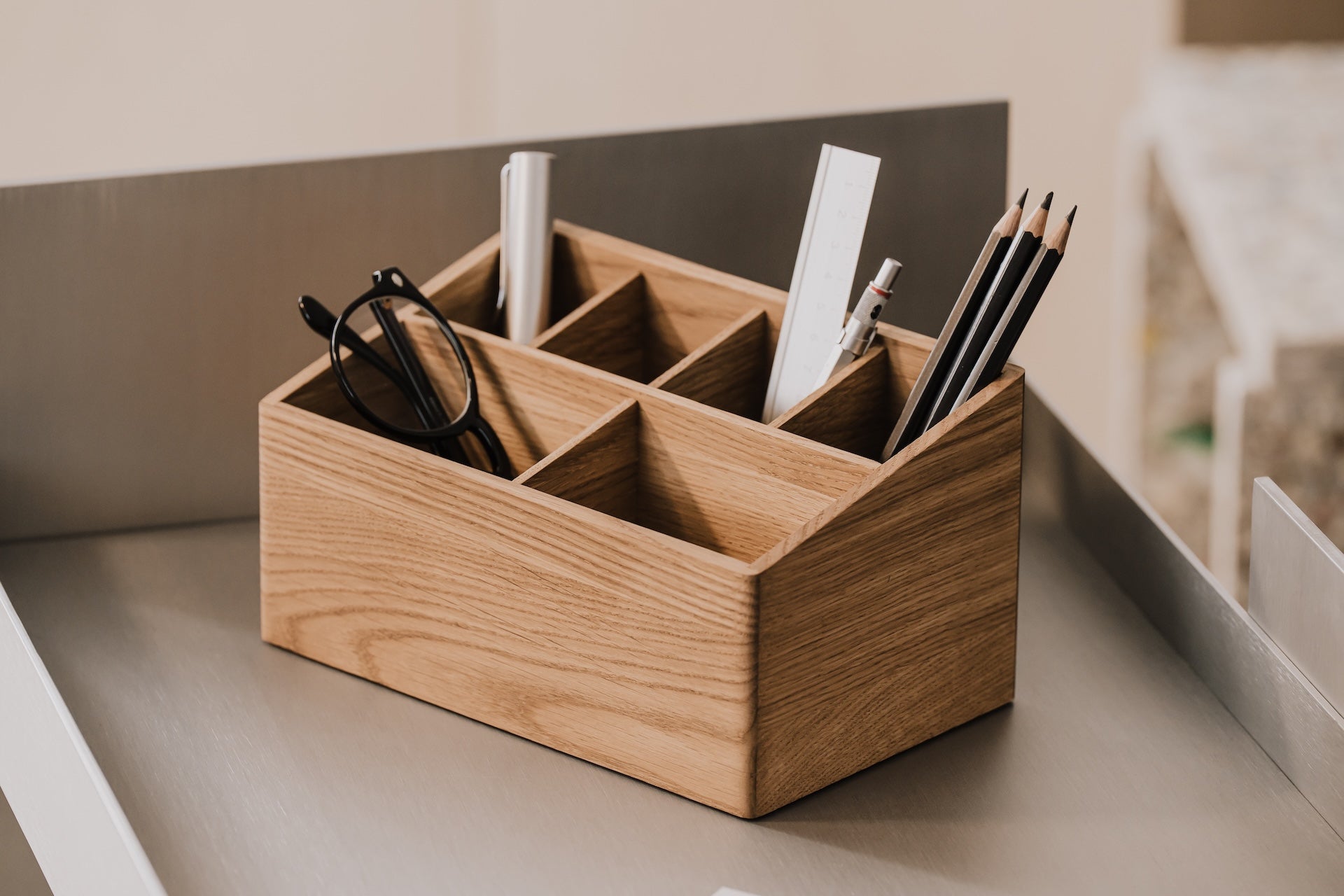 Wooden oak desk organizer with stationery items on a neutral background | oak
