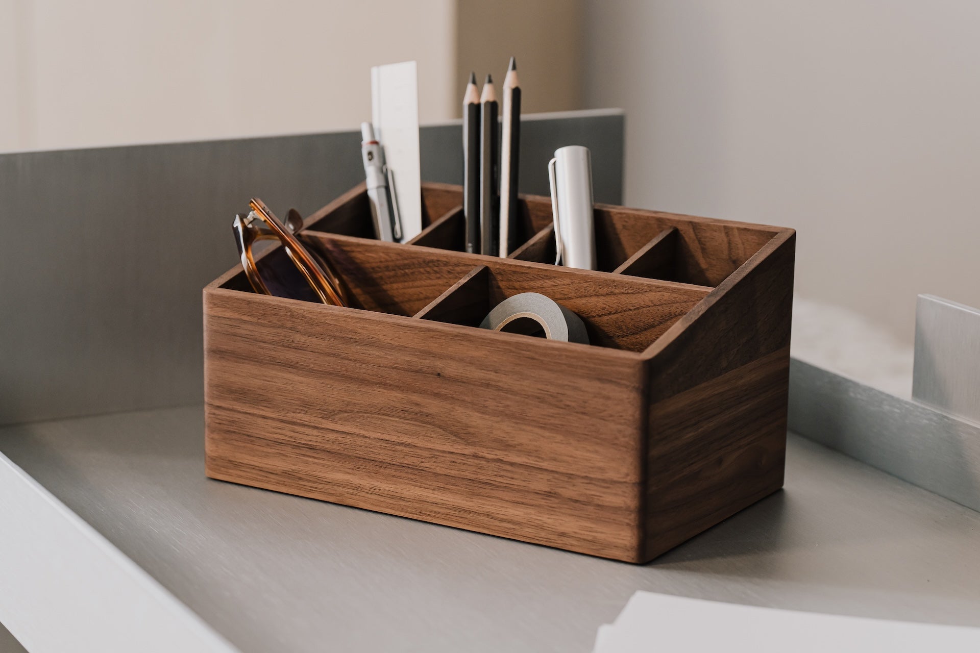 Wooden desk organizer with office supplies on a neutral background | walnut