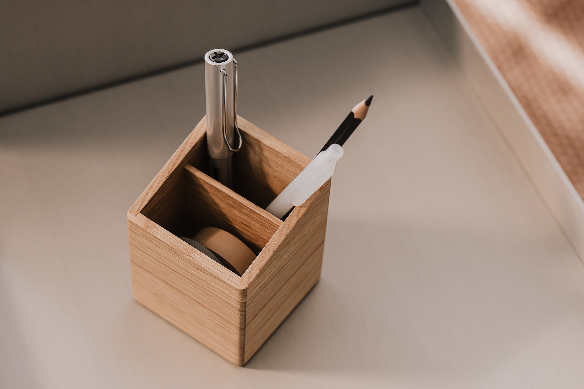 Wooden pen holder with a pen and pencil on a neutral background | oak
