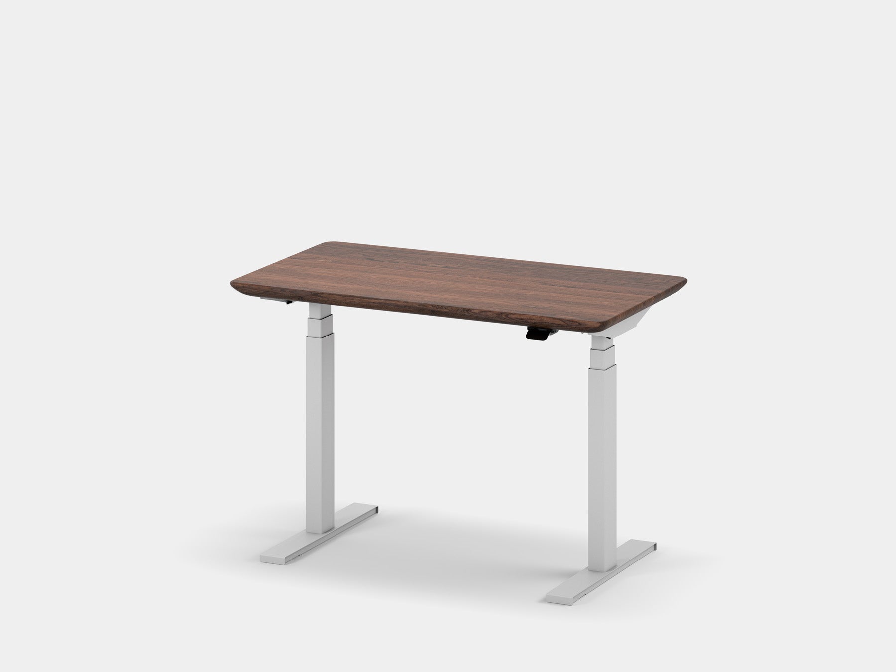 Another view of a compact height-adjustable desk with a dark tabletop and light gray legs.