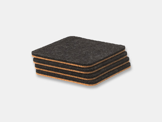 Stack of black square coasters with cork backing on a light gray background oakywood | anthracite