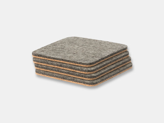 Stack of gray felt coasters on a light gray background oakywood | grey