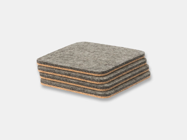 Stack of gray felt coasters on a light gray background oakywood | grey