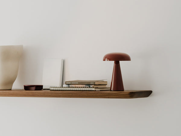 Close-up of a curved wooden shelf edge showing wood grain
