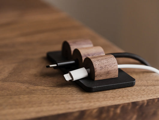 Wooden cable management system on a wooden surface | walnut, 