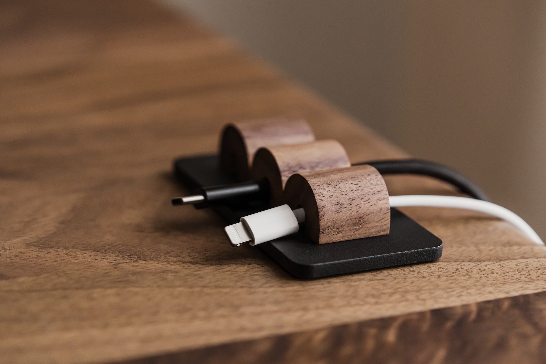 Wooden cable management system on a wooden surface | walnut, 