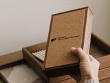 Hand holding a wooden box with a cork finish and visible Oakywood brand logo | walnut, 
