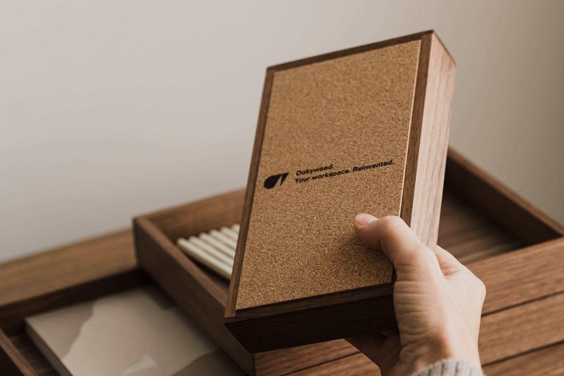 Hand holding a wooden box with a cork finish and visible Oakywood brand logo | walnut, 