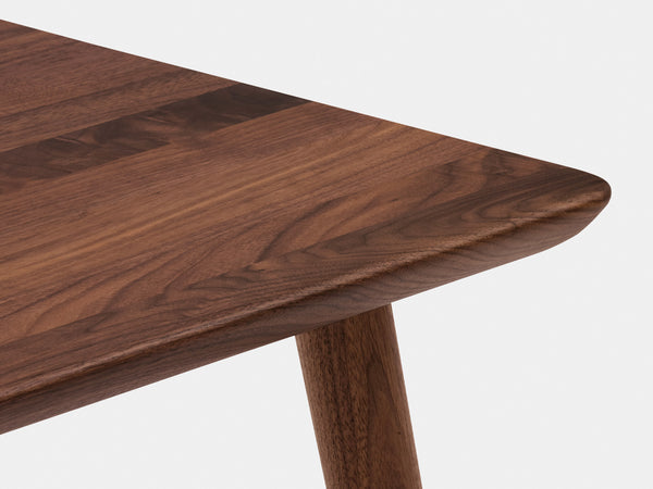 Close-up of edge and layered plywood edge detail of light wood desk.